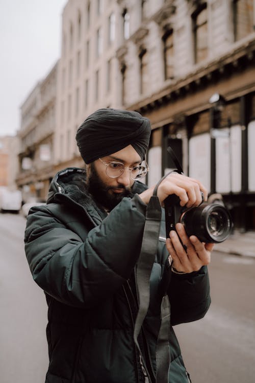 A man in a turban holding a camera