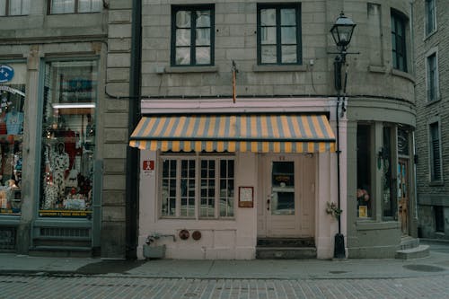 A yellow and white striped awning on a building