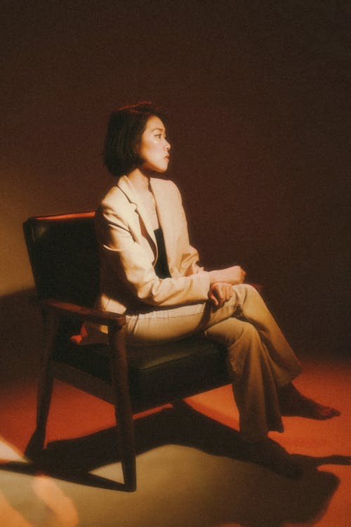 A woman sitting in a chair with her head down