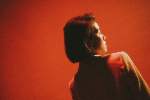 A woman in a red room with a red background