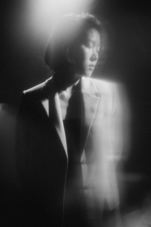 Free Blurry black and white portrait of a woman in spotlight, conveying artistry. Stock Photo