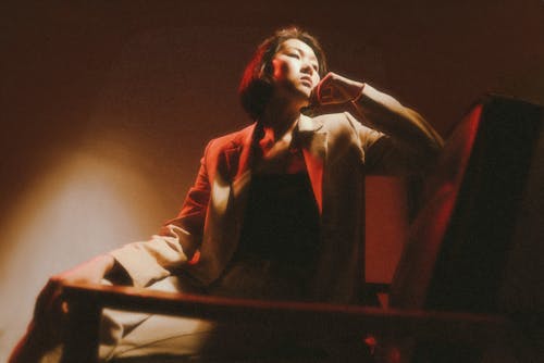 A woman sitting on a chair with a red light