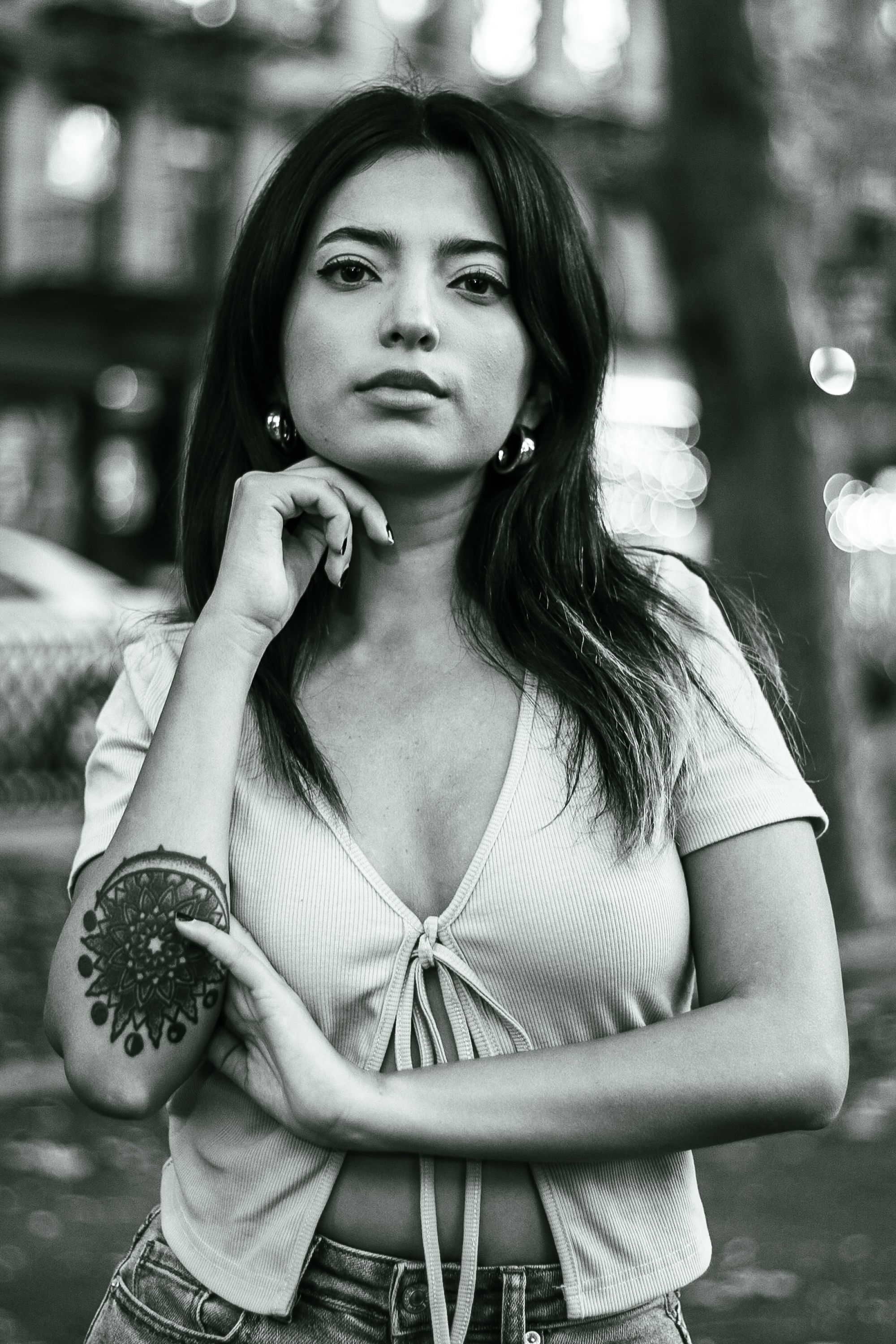 Stylish black and white portrait of a young woman with tattoos in New York City.