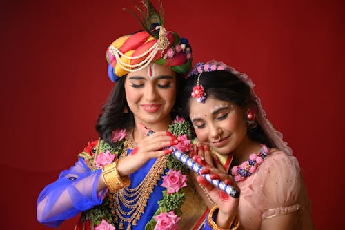 Two women in traditional attire posing for a photo