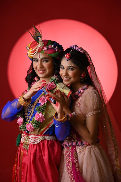 Two women in traditional indian attire posing for a photo