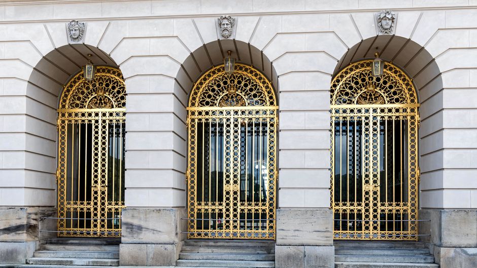 Elegant architectural details of Neues Schloss Herrenchiemsee with golden gates.