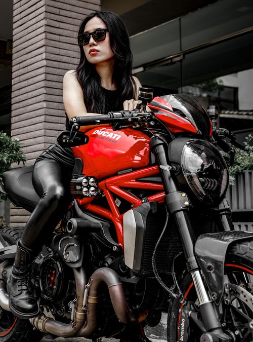 Free Stylish woman posing on Ducati motorcycle in Ho Chi Minh City, Vietnam. Stock Photo