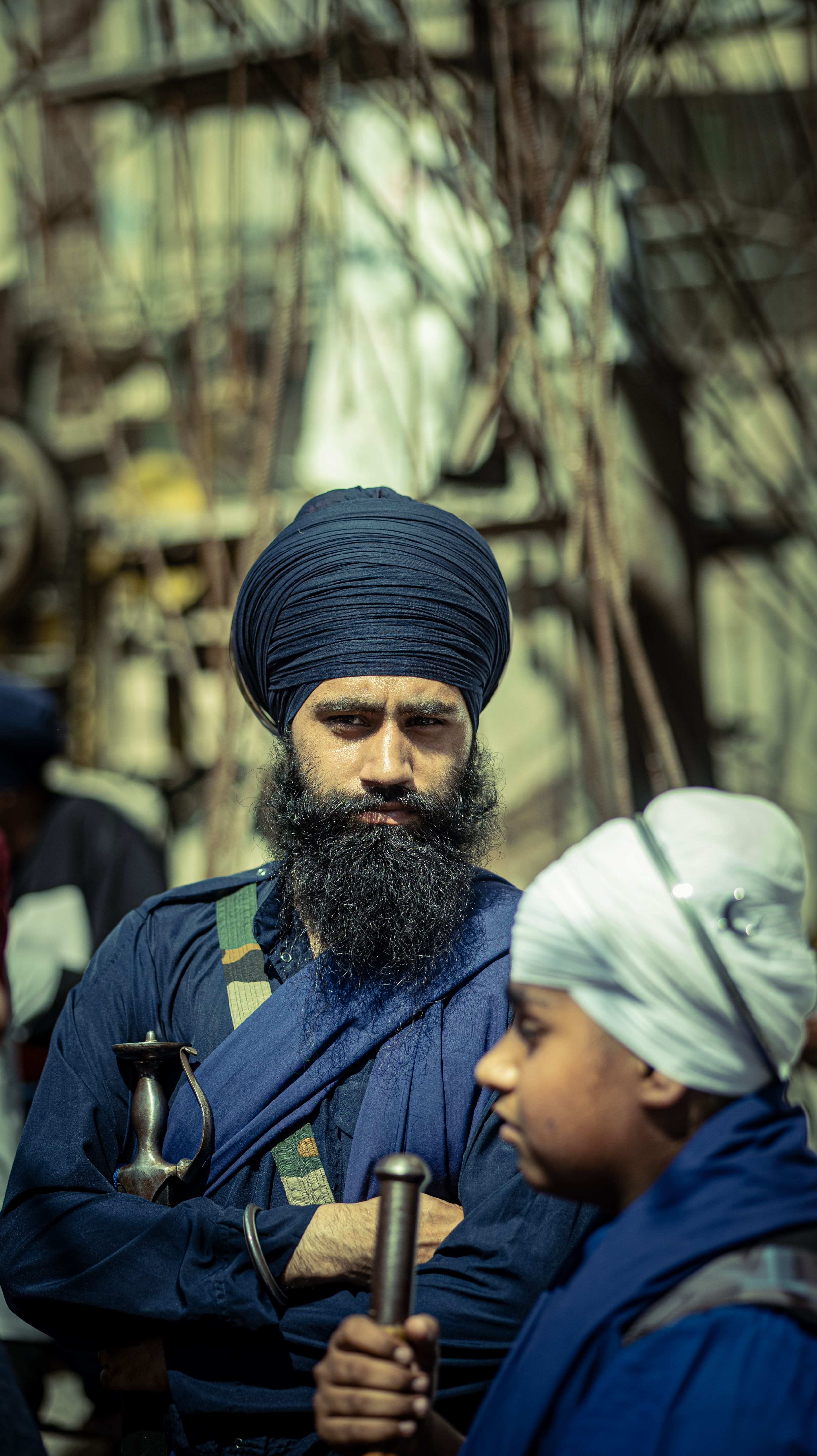 Two Sikh men in traditional attire with turbans and swords in Anandpur Sahib, India.
