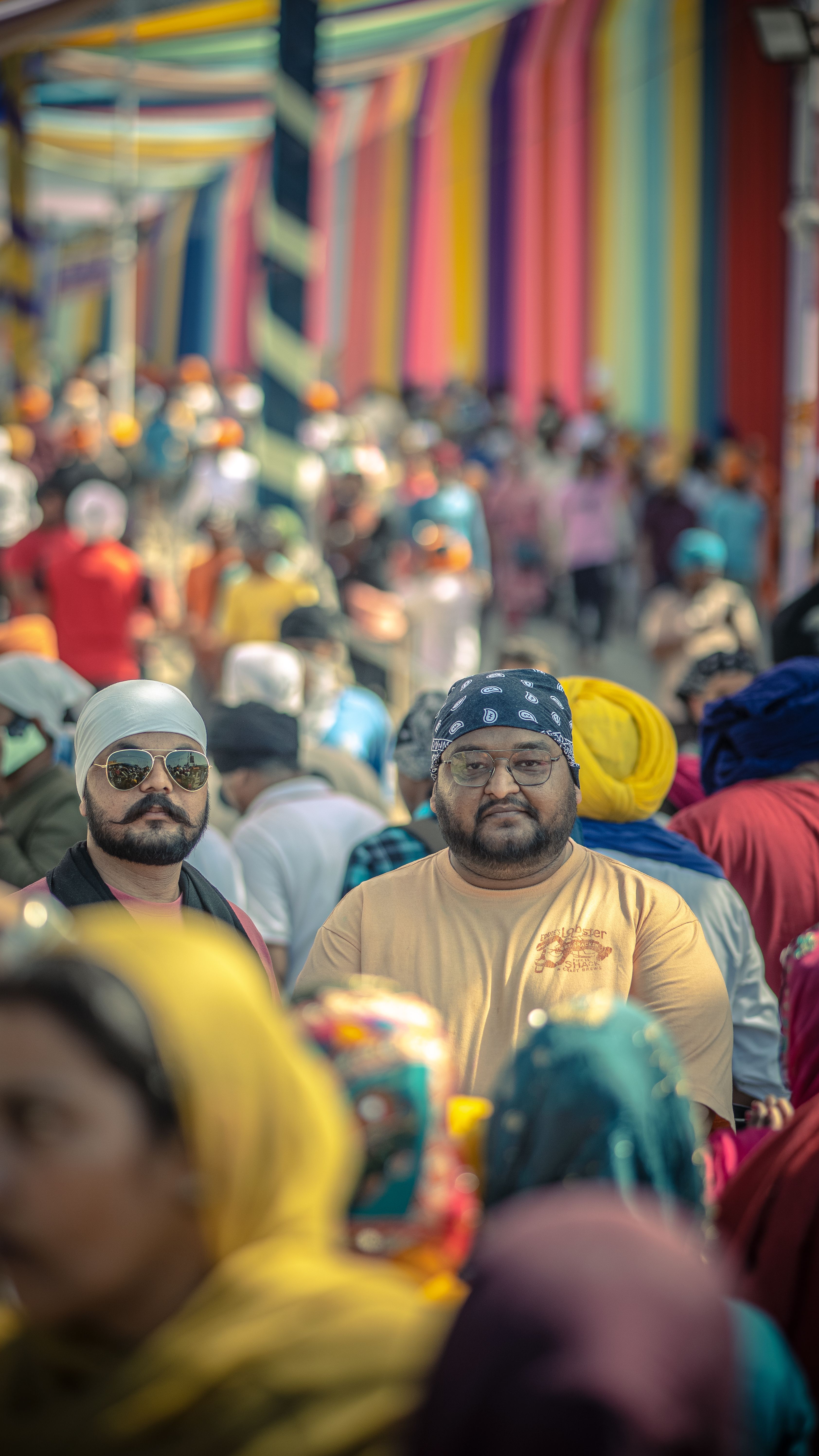 Vibrant street festival showcasing colorful decorations and diverse people enjoying the event.