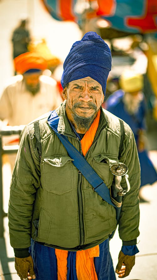 A man in a turban and blue jacket
