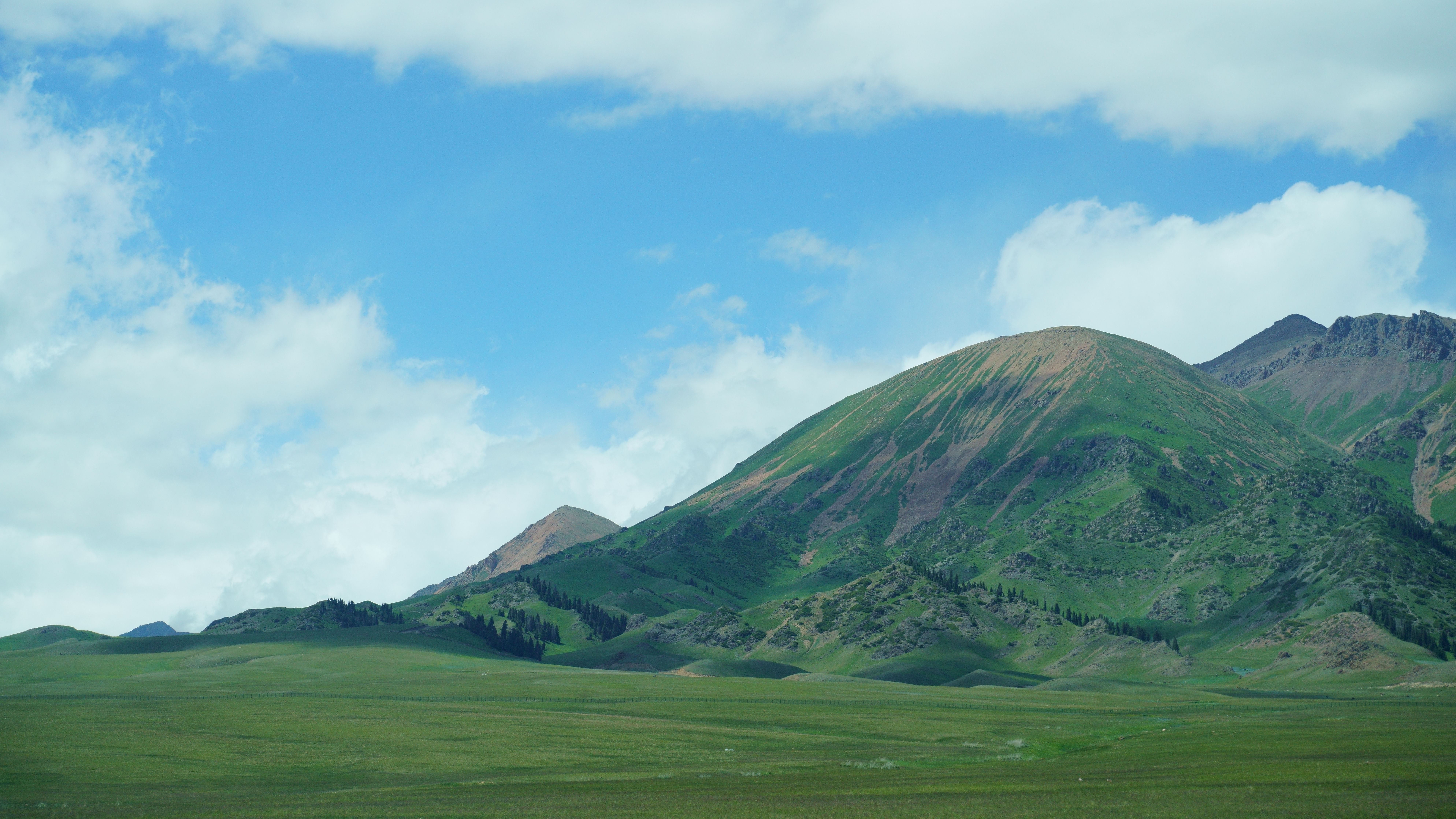 Landscape of Hills and Field · Free Stock Photo