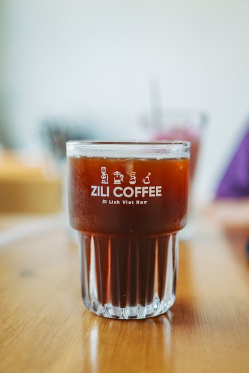 A glass of coffee sitting on a table