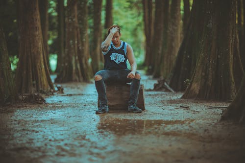 Person Sitting on Log