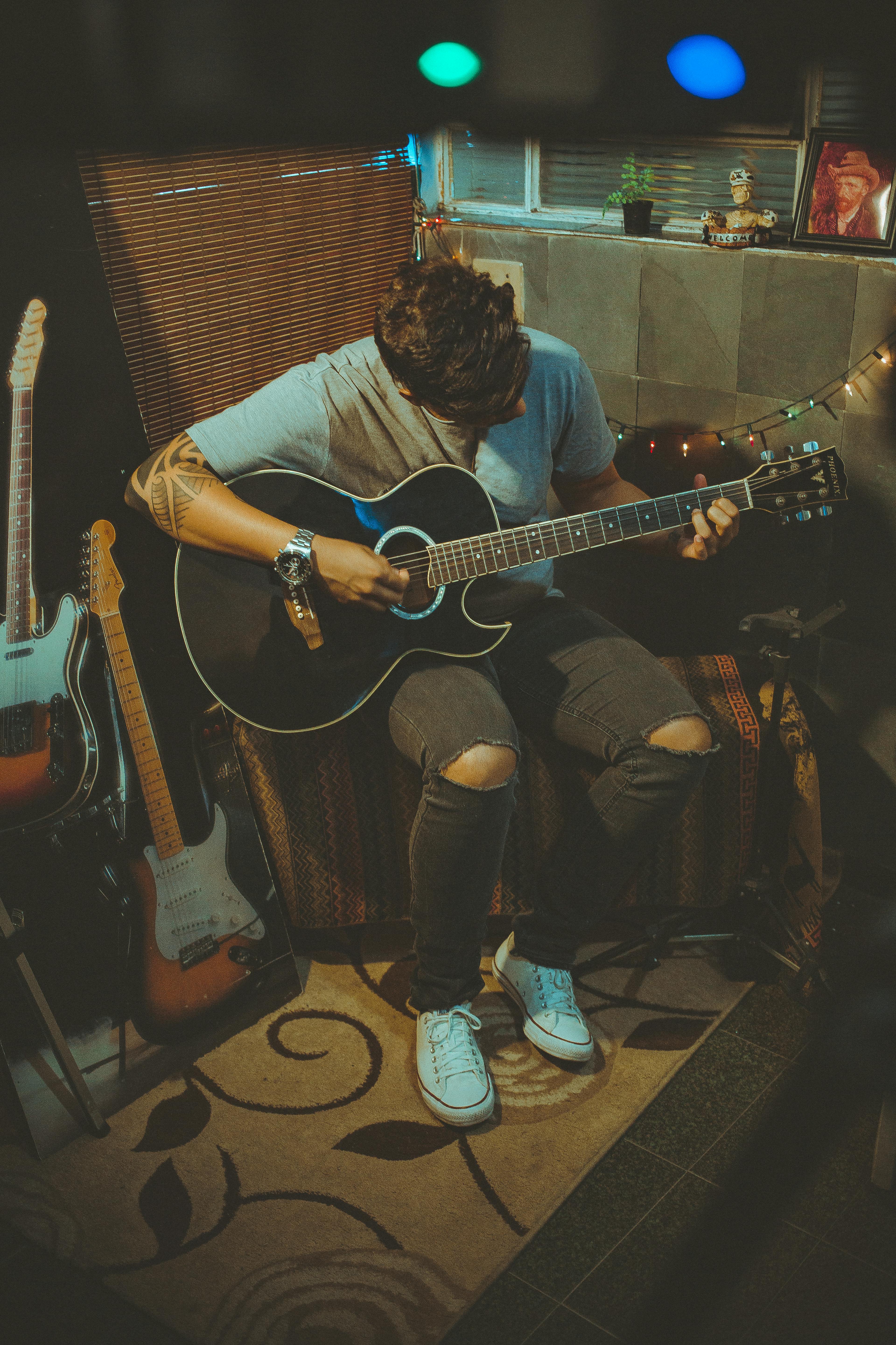 Person Playing Guitar