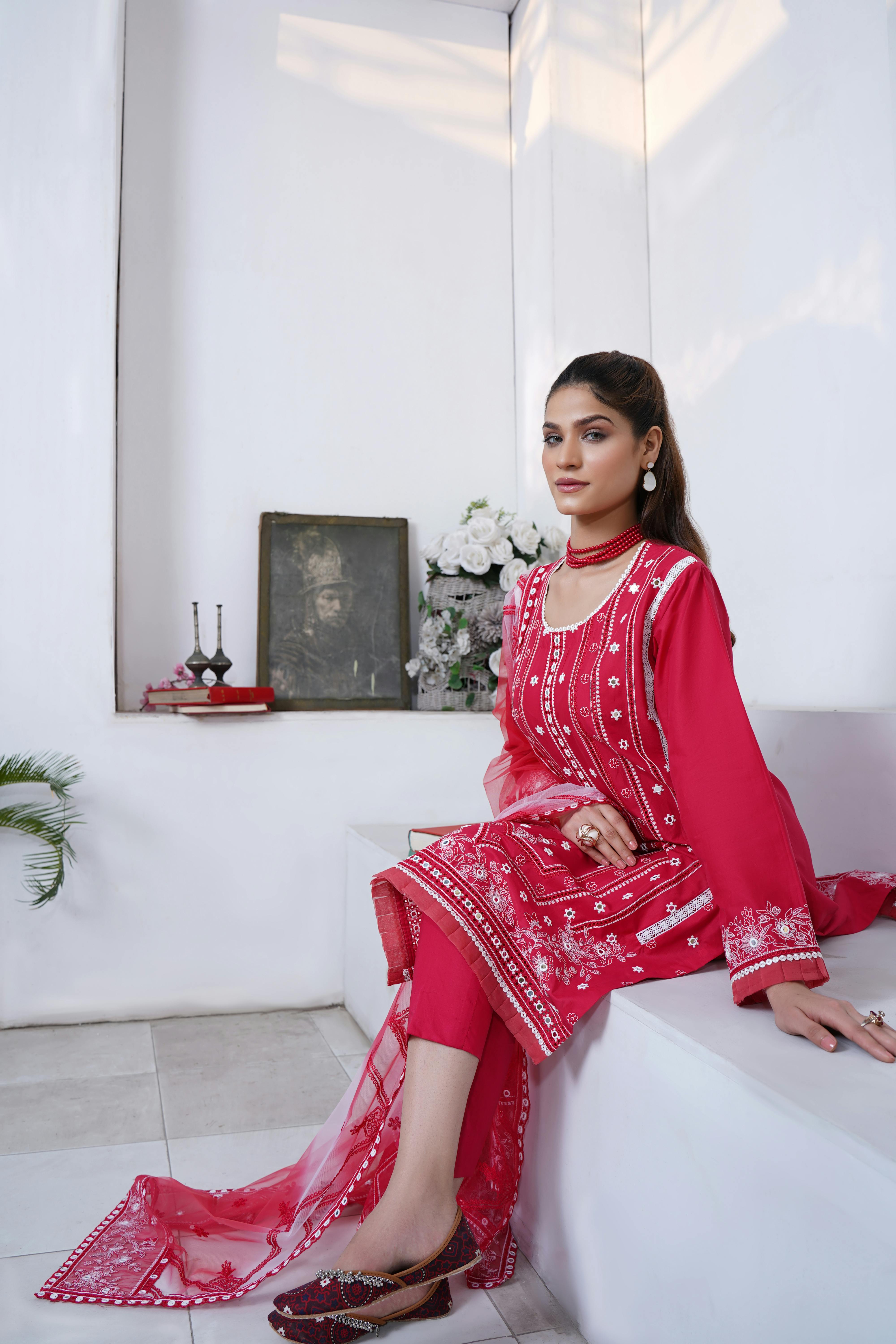 woman sitting in red traditional clothing