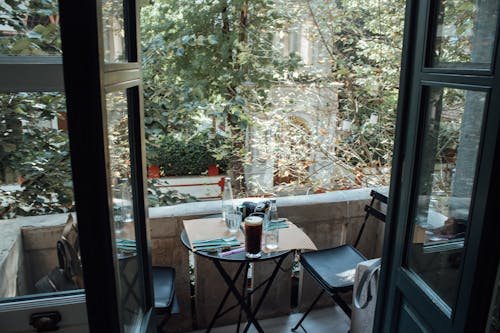 Glass Bottles on Table on Porch