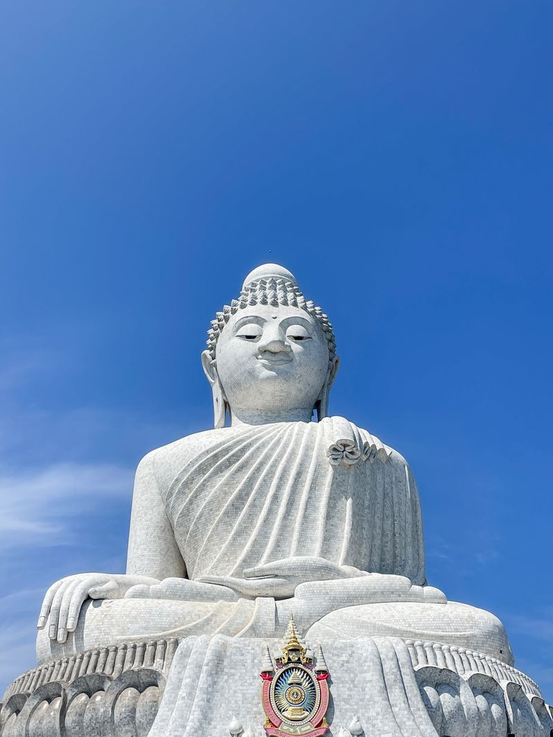 Great Big Buddha marble statue of Phuket against a deep blue sky