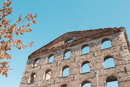 Free Shabby facade of medieval ruined building Stock Photo