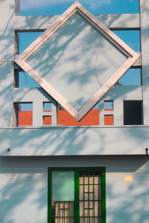 A building with a large window and green door