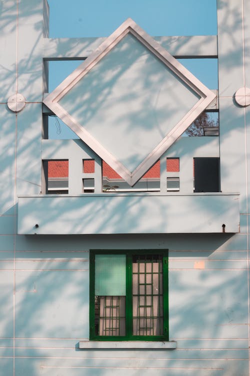 A building with a window and a green door