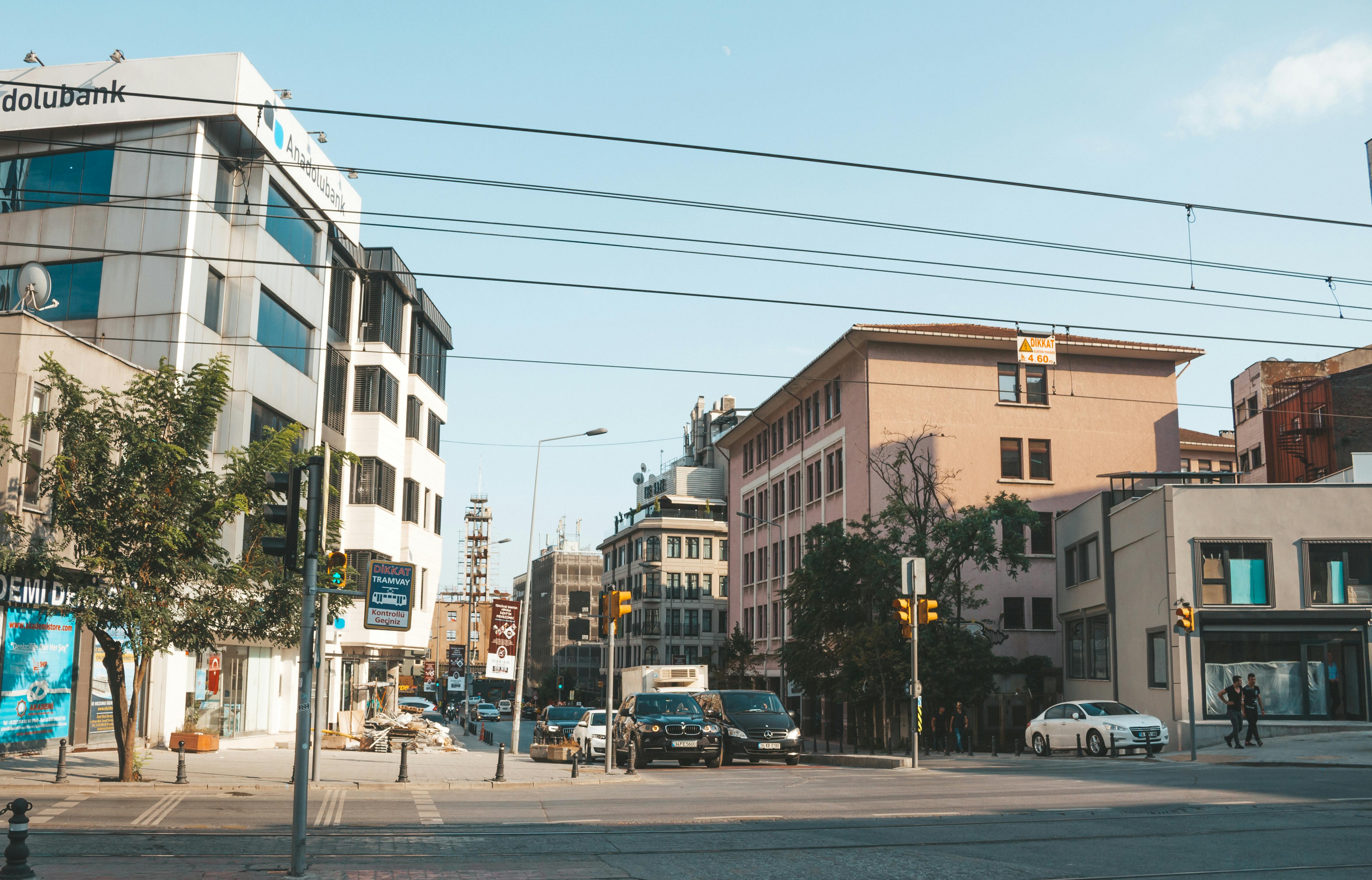 vehicles travelling on road near buildings