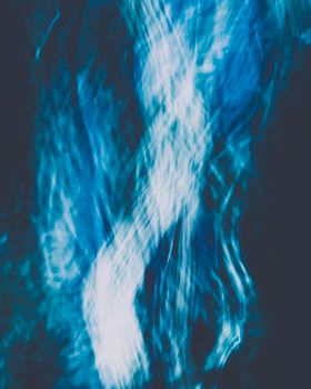 Dynamic abstract art capturing fluid motion in cool blue tones.