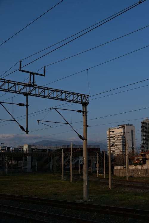 A train tracks and a city skyline in the background