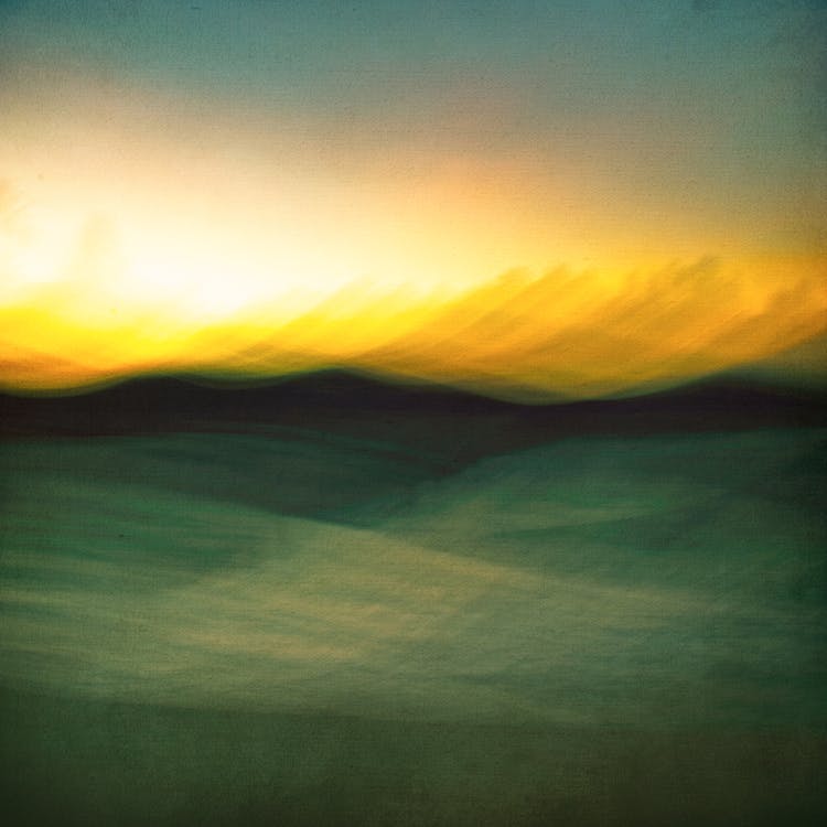 A sunset over a field with a blurry image