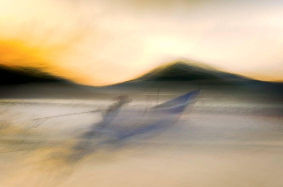 A blurry photo of a boat on the beach