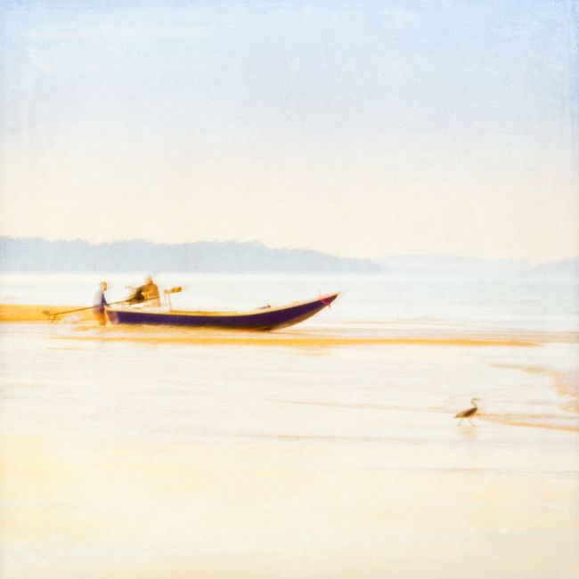 Ethereal dawn scene with a canoe, reflecting warm hues and calm waters.
