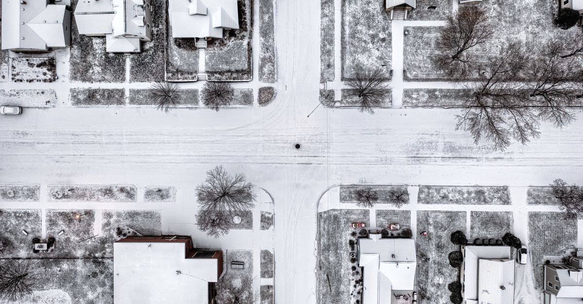 Aerial view of Wabasha, MN streets blanketed in snow, showcasing a serene winter landscape.