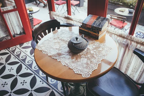 Black Kettle on Brown and Black Wooden Coffee Table