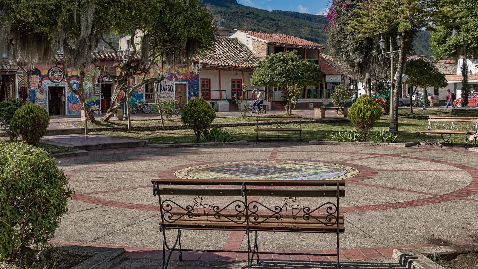 Small park with a bench and trees in a town by the mountain, Comoros