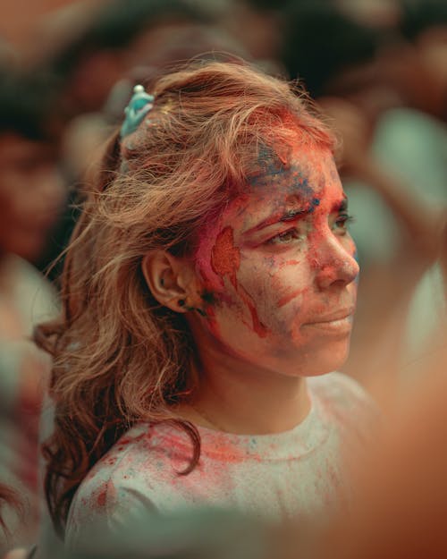 A woman with paint on her face and hair