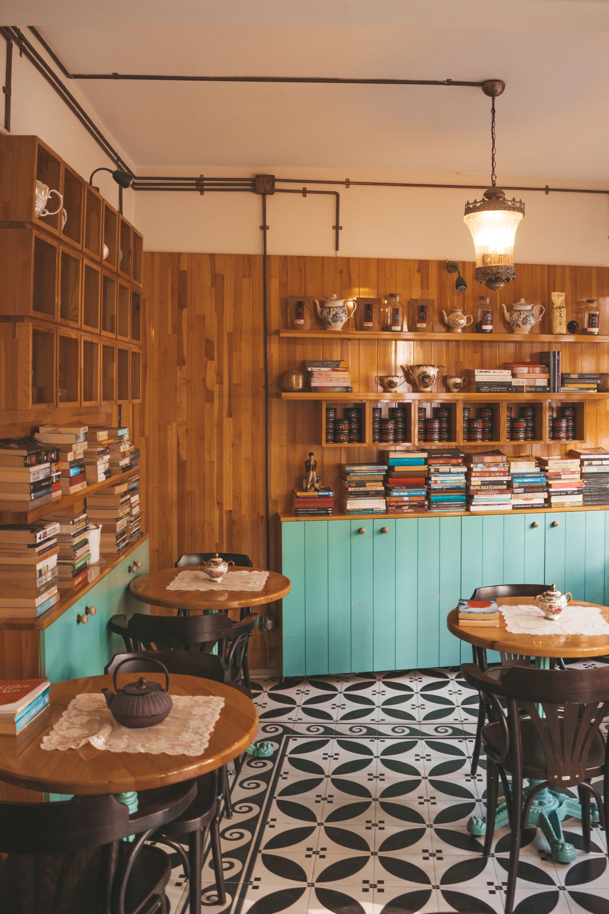 Warm and inviting independent coffee shop interior with books and wooden walls