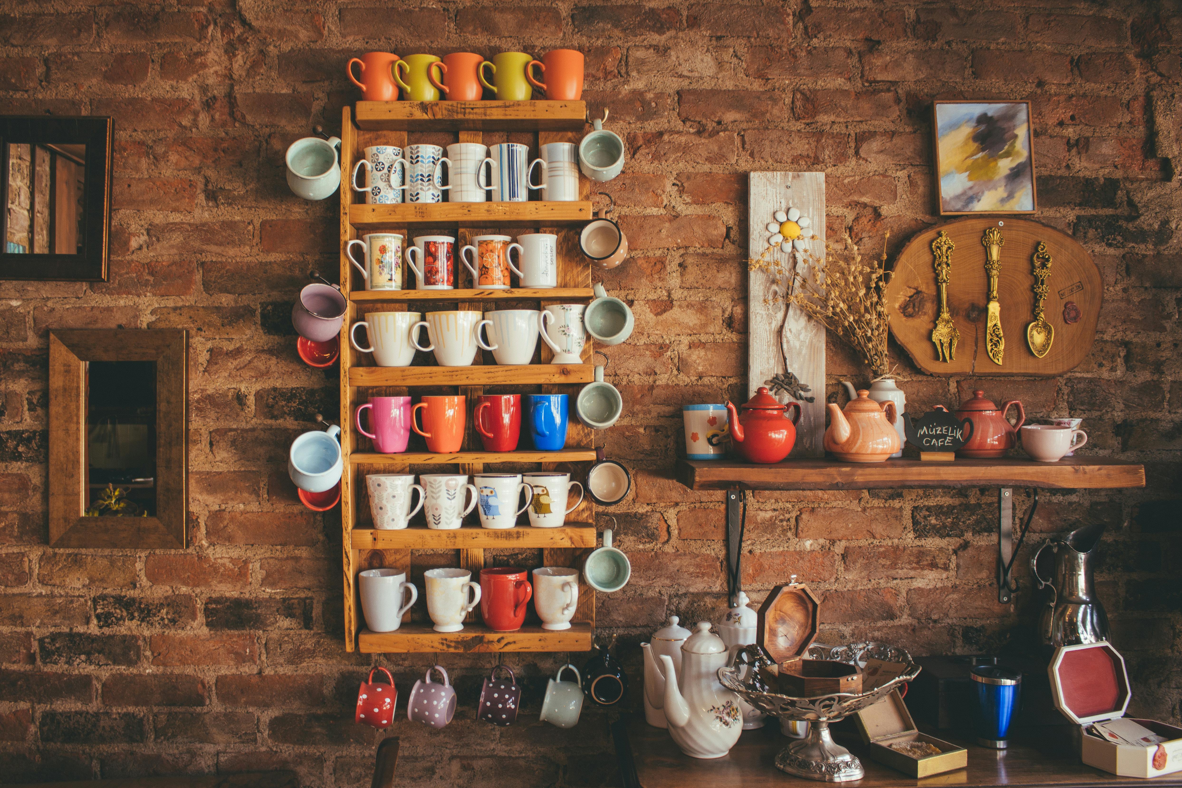 colorful mugs on a crick wall