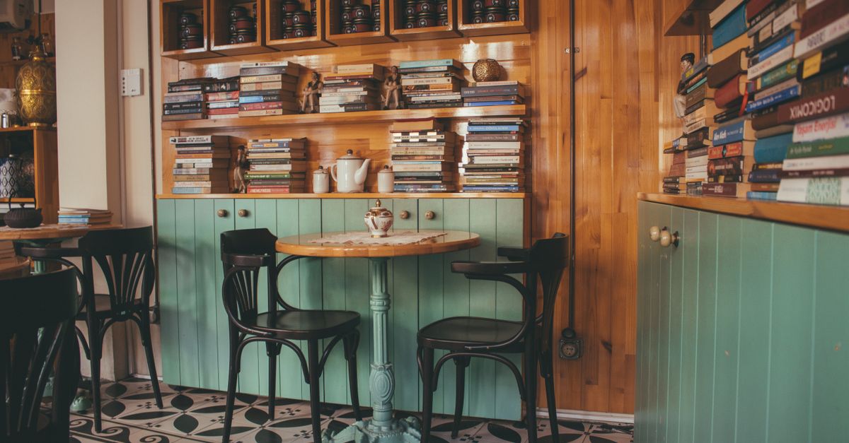 cozy coffee shop interior with people reading books and chatting