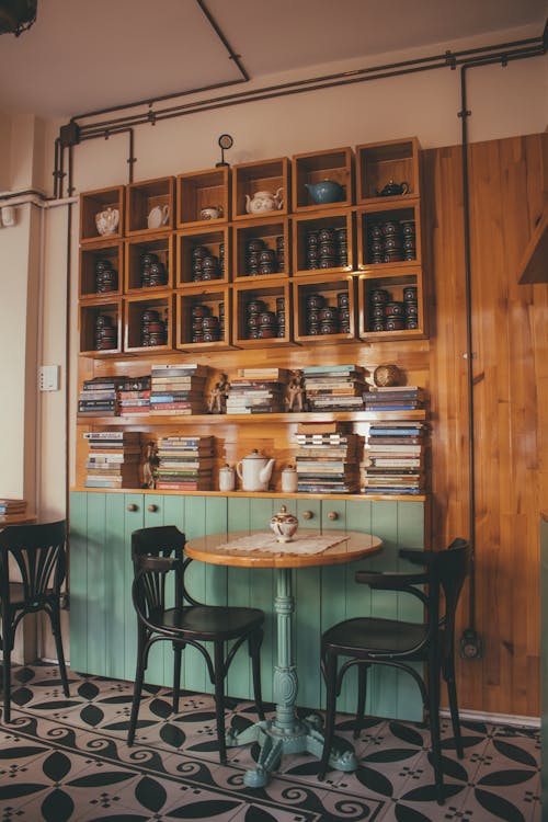 Brown Wooden Table With Two Black Chairs Inside Room