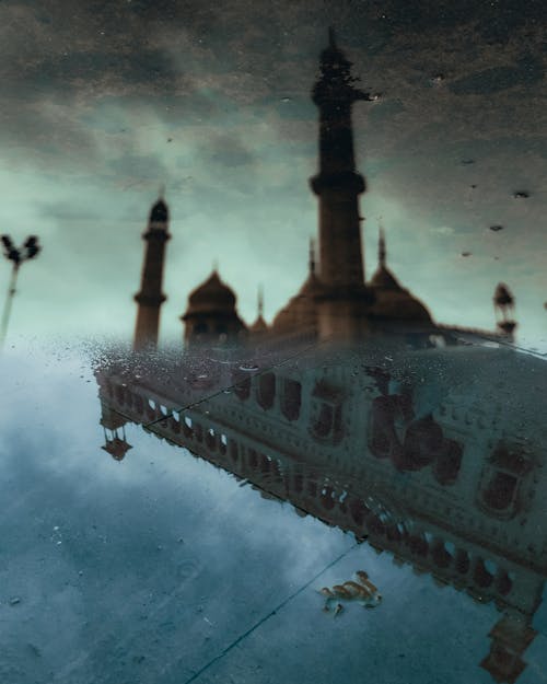 A photo of a mosque with a man floating in the water