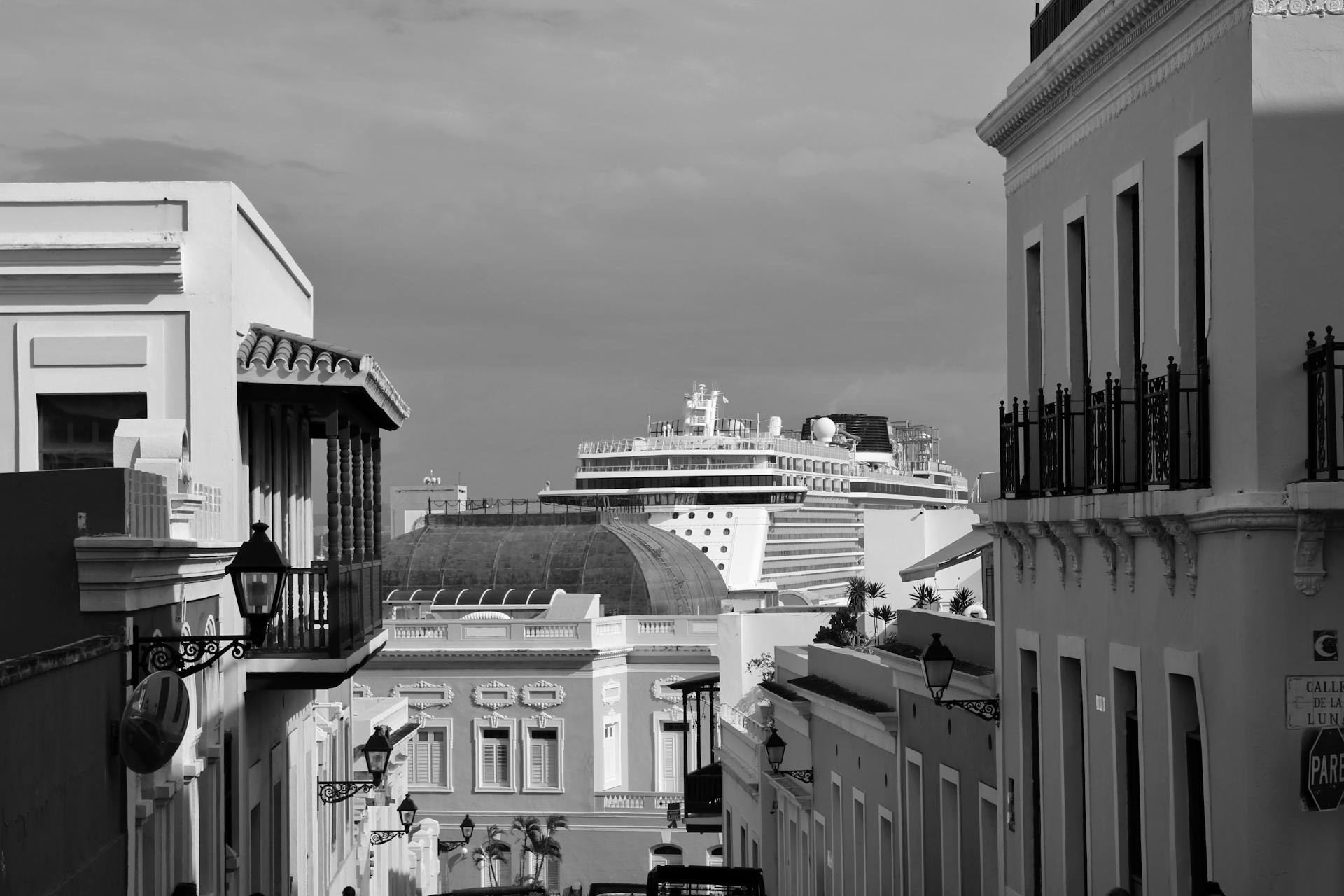 Captivating grayscale image of Old San Juan, Puerto Rico with a cruise ship in the background.