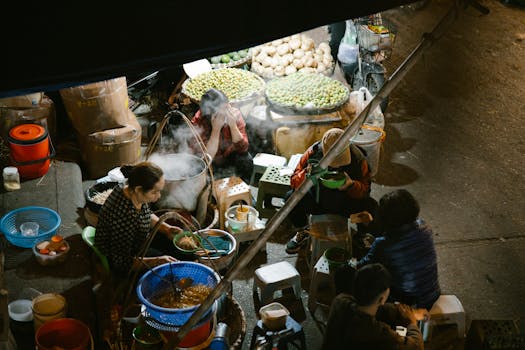 High angle view of people enjoying food at a vibrant night market.