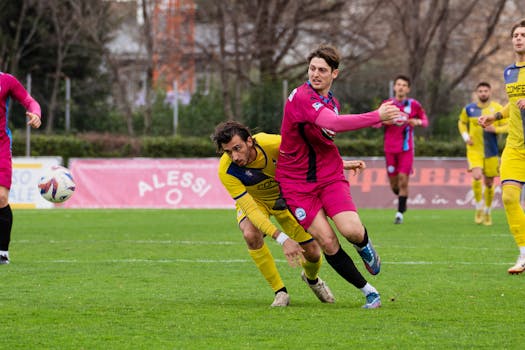 Dynamic action shot of soccer players competing during a match outdoors.