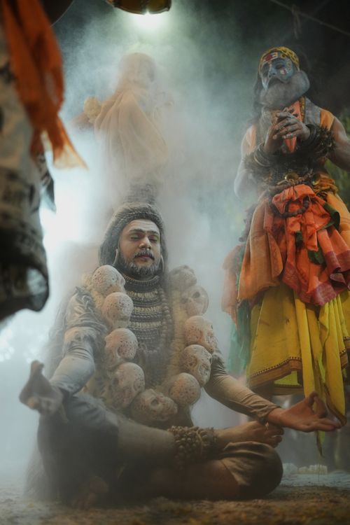 Free Mystical tribal ceremony with costumed figures in a spiritual setting surrounded by smoke. Stock Photo