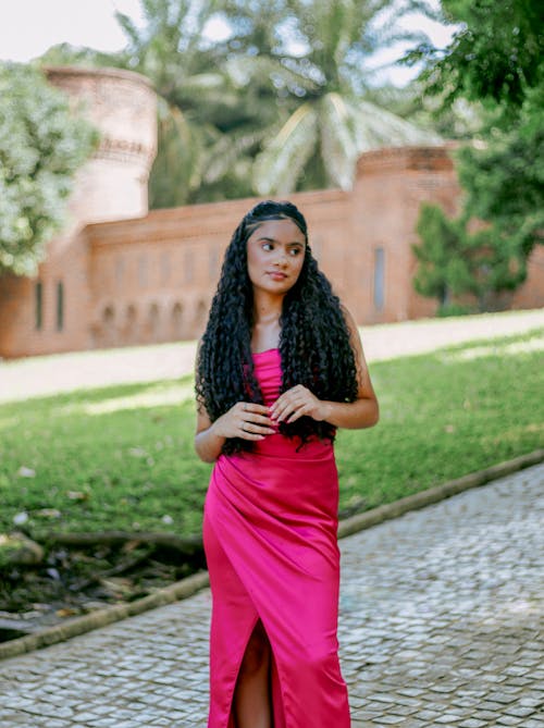 A woman in a pink dress posing for a photo