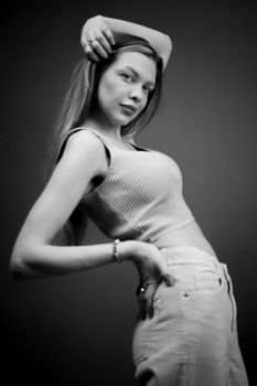 Elegant black and white portrait of a stylish woman posing confidently.