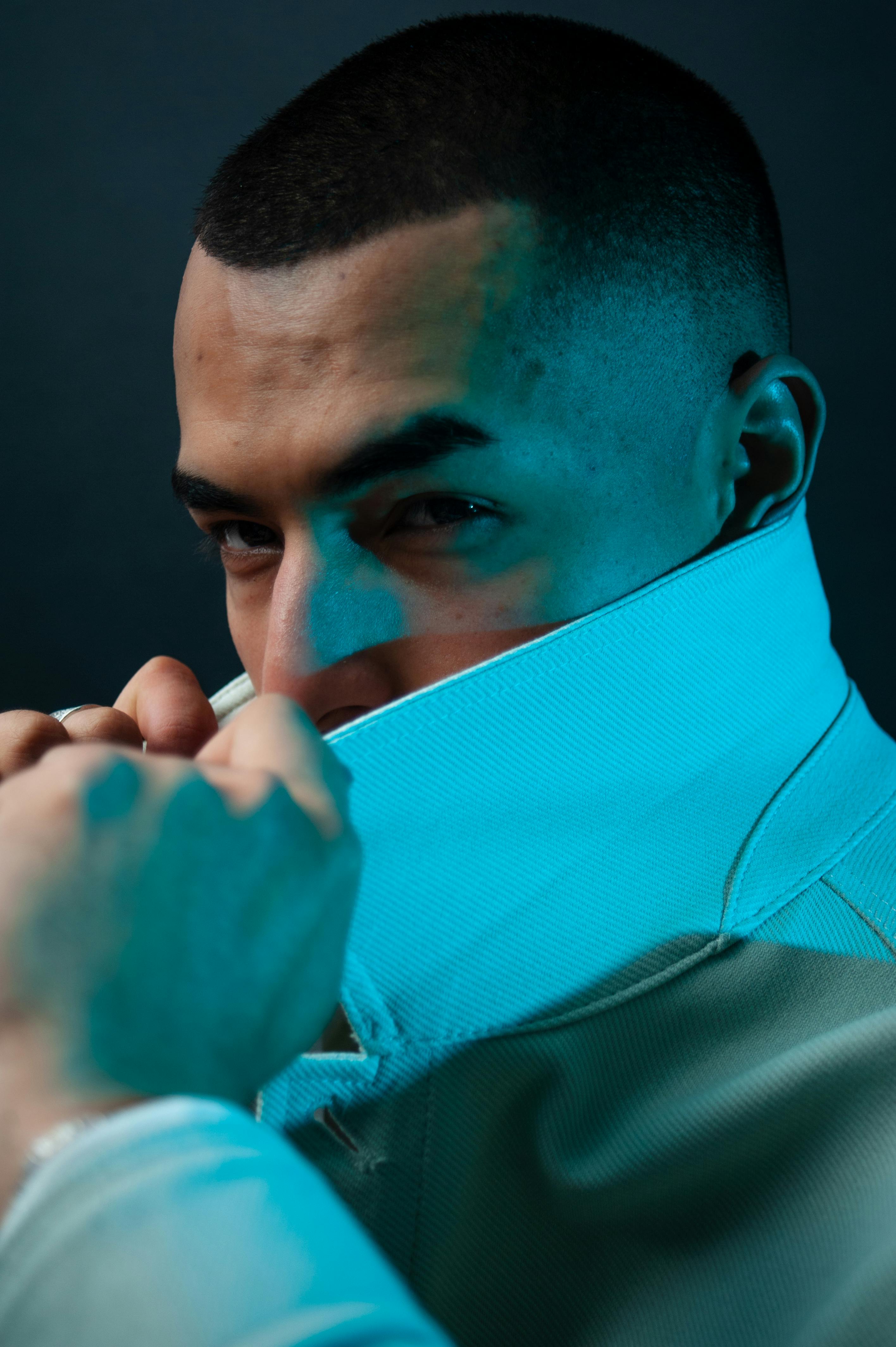 Free Close-up fashion portrait of a man with a jacket collar up, creating a mysterious look. Stock Photo