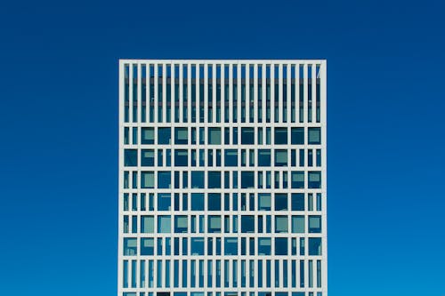 A tall building with windows against a blue sky