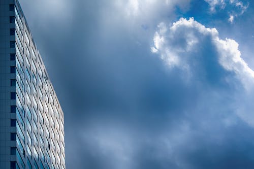 A building with a blue sky and clouds