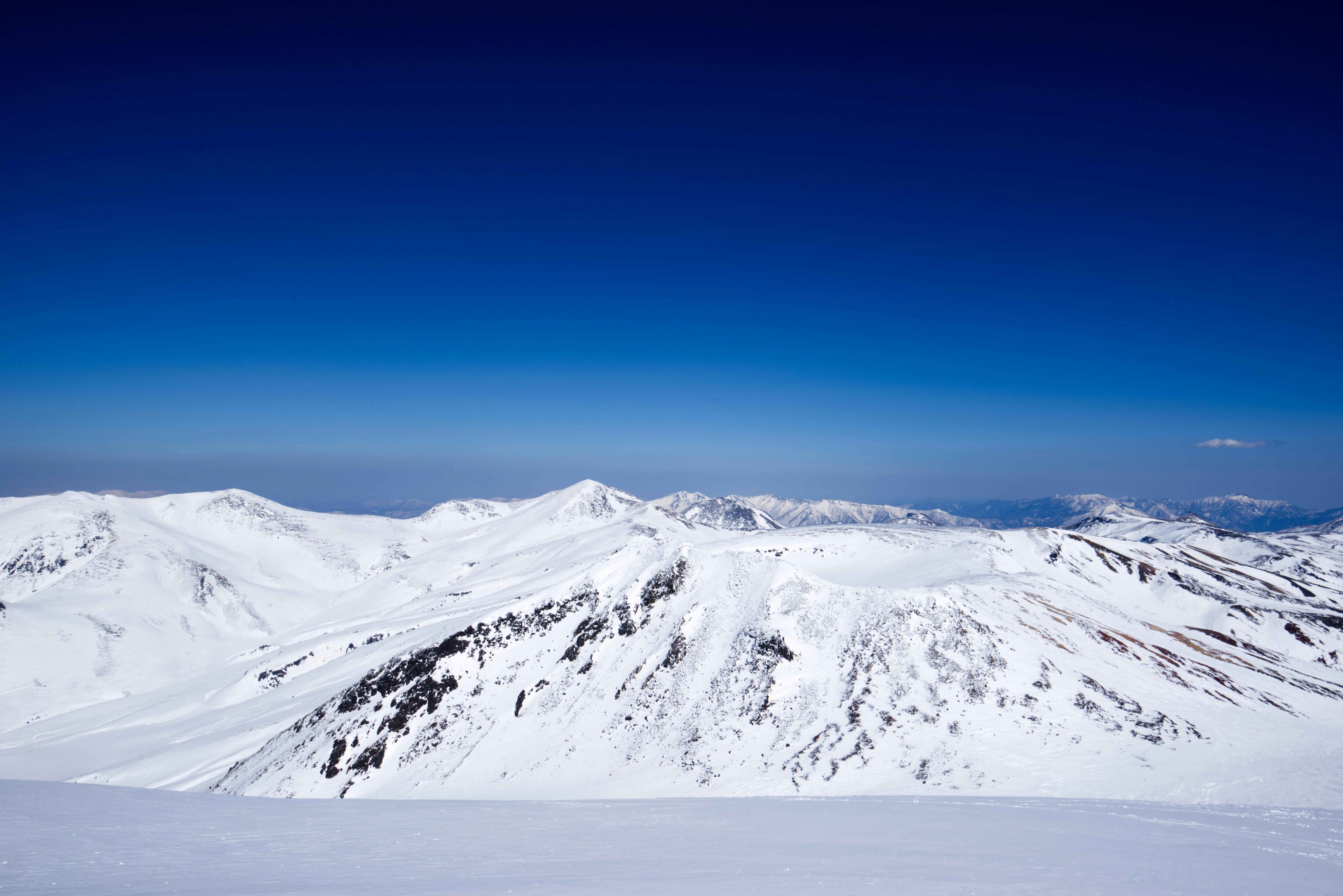 Stunning winter landscape of snow-covered mountains in Hokkaido, Japan.
