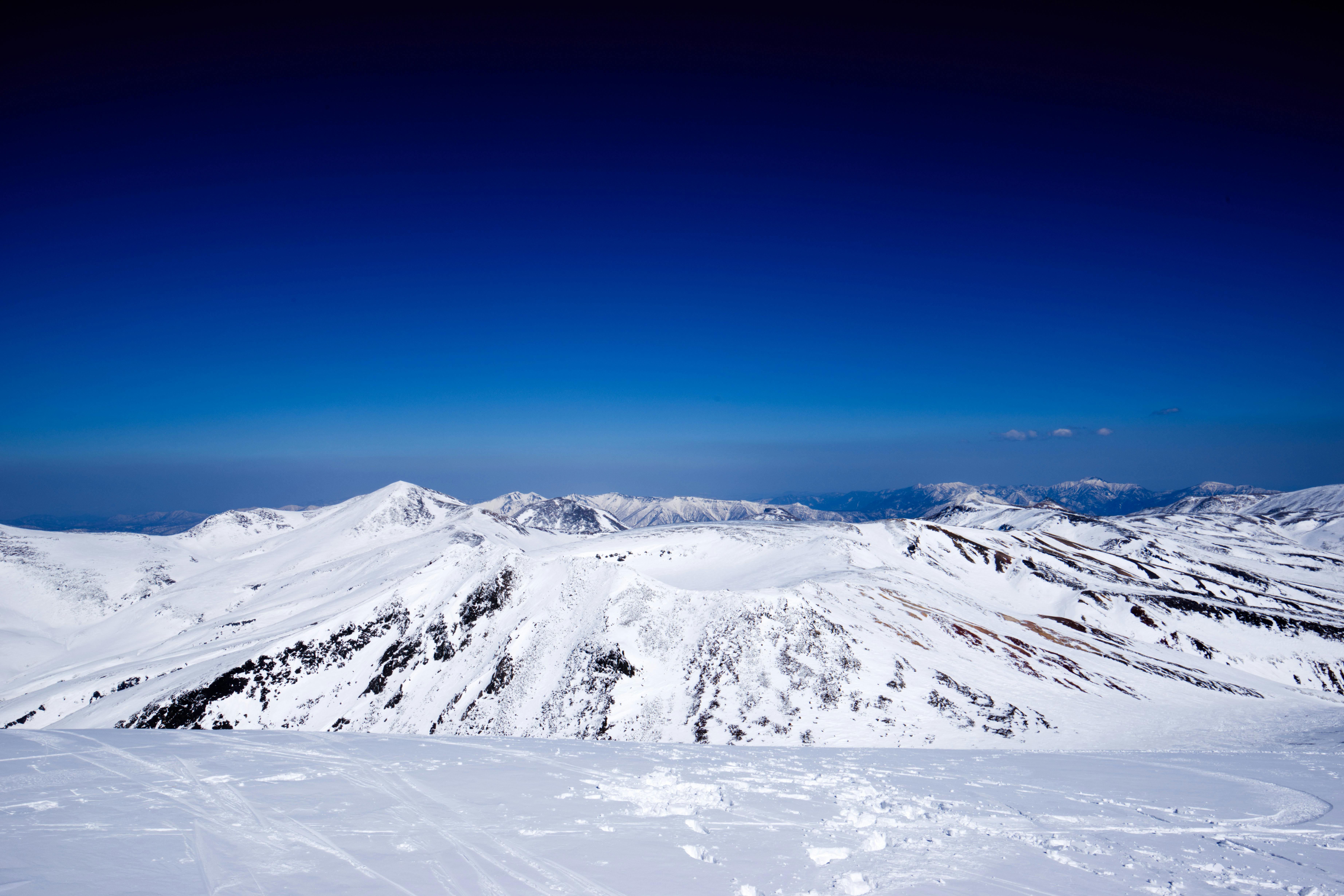 Scenic view of snow-covered peaks in Higashikawa, Hokkaido, Japan.